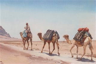 Camel train in desert landscape